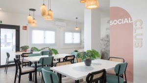 Zona de juegos infantiles con columpios y tobogán en área común de promoción residencial